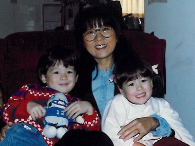 Sun Min Kimes is holding both Mina Kimes and Isaac Kimes in the picture.